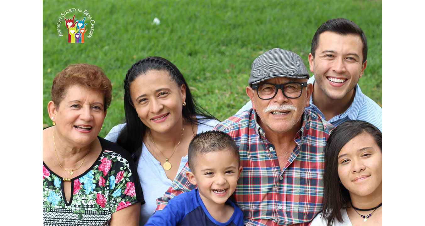 image shows a happy multigenerational Latinx family