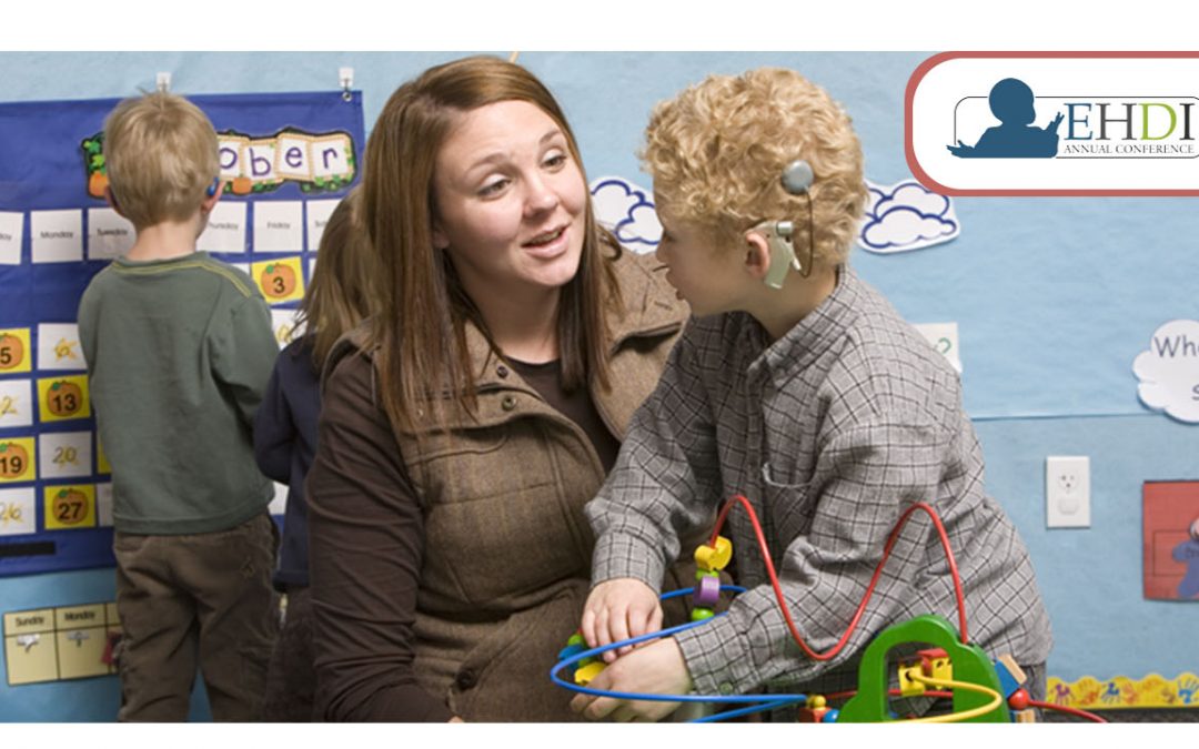 EHDI Conference 2021 - image shows a teacher talking with a young student with a cochlear implant